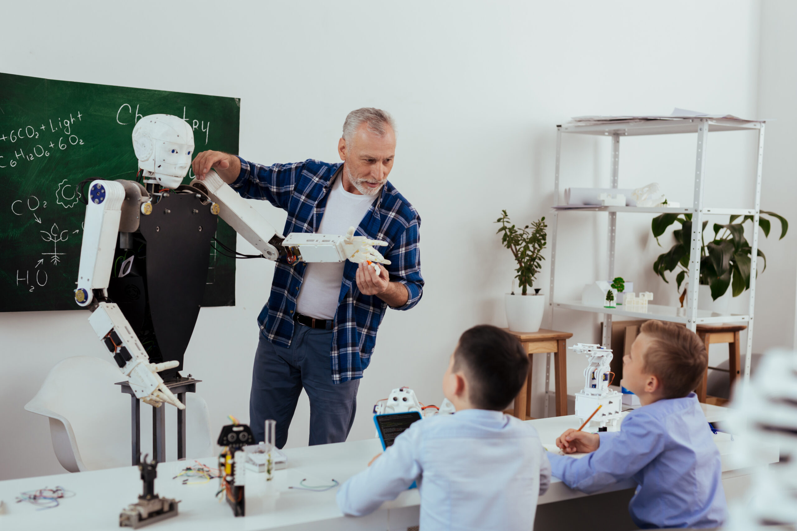 Futuristic developments. Nice diligent pupils taking notes while listening to their teacher