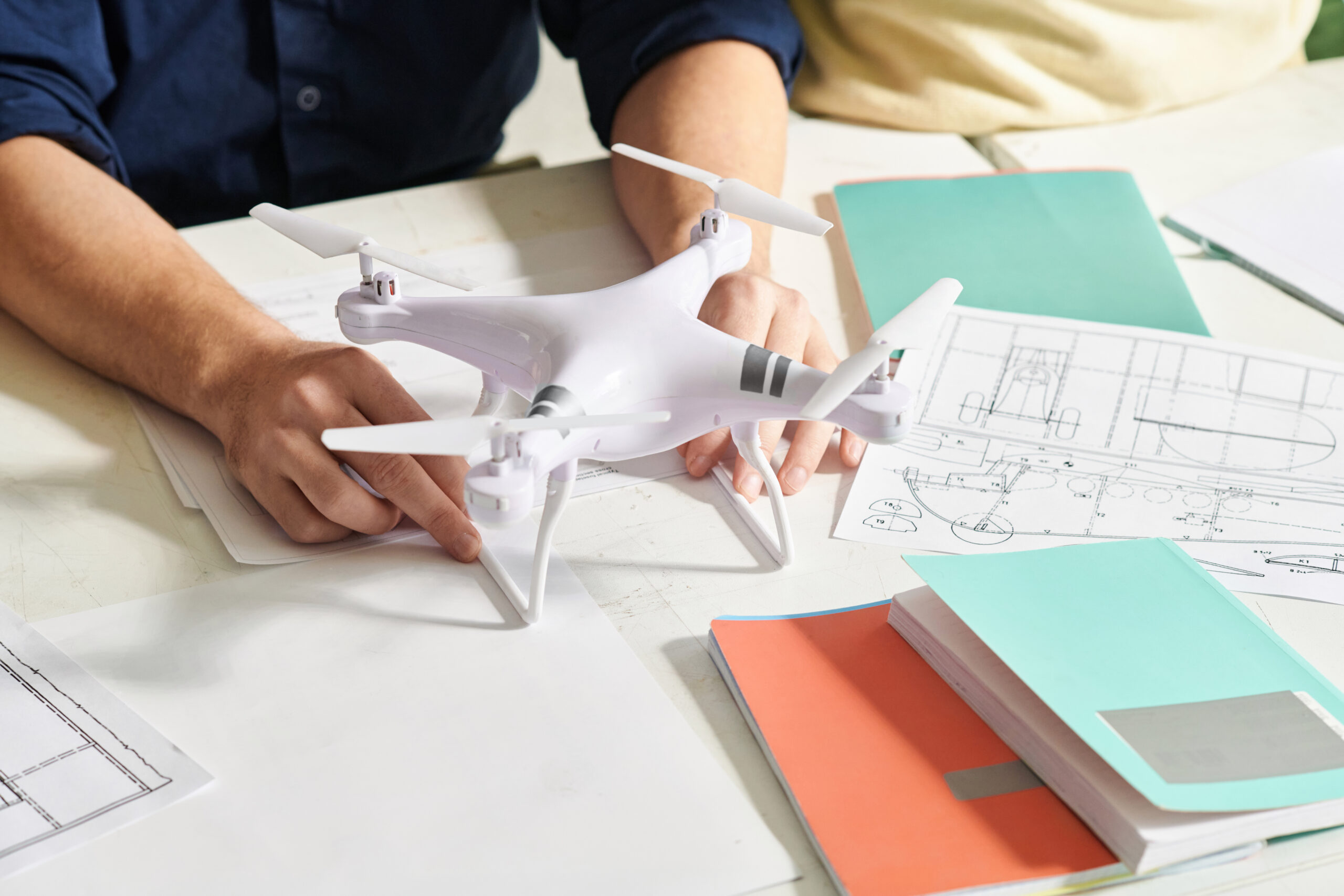 Man following instructions in manual when assembling quadcopter